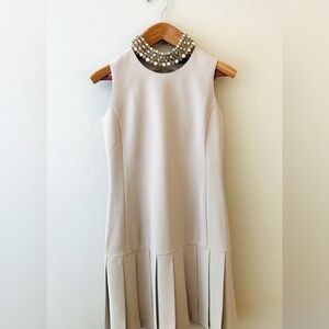 Sleeveless Beige Pleated-Hem Mini Dress
